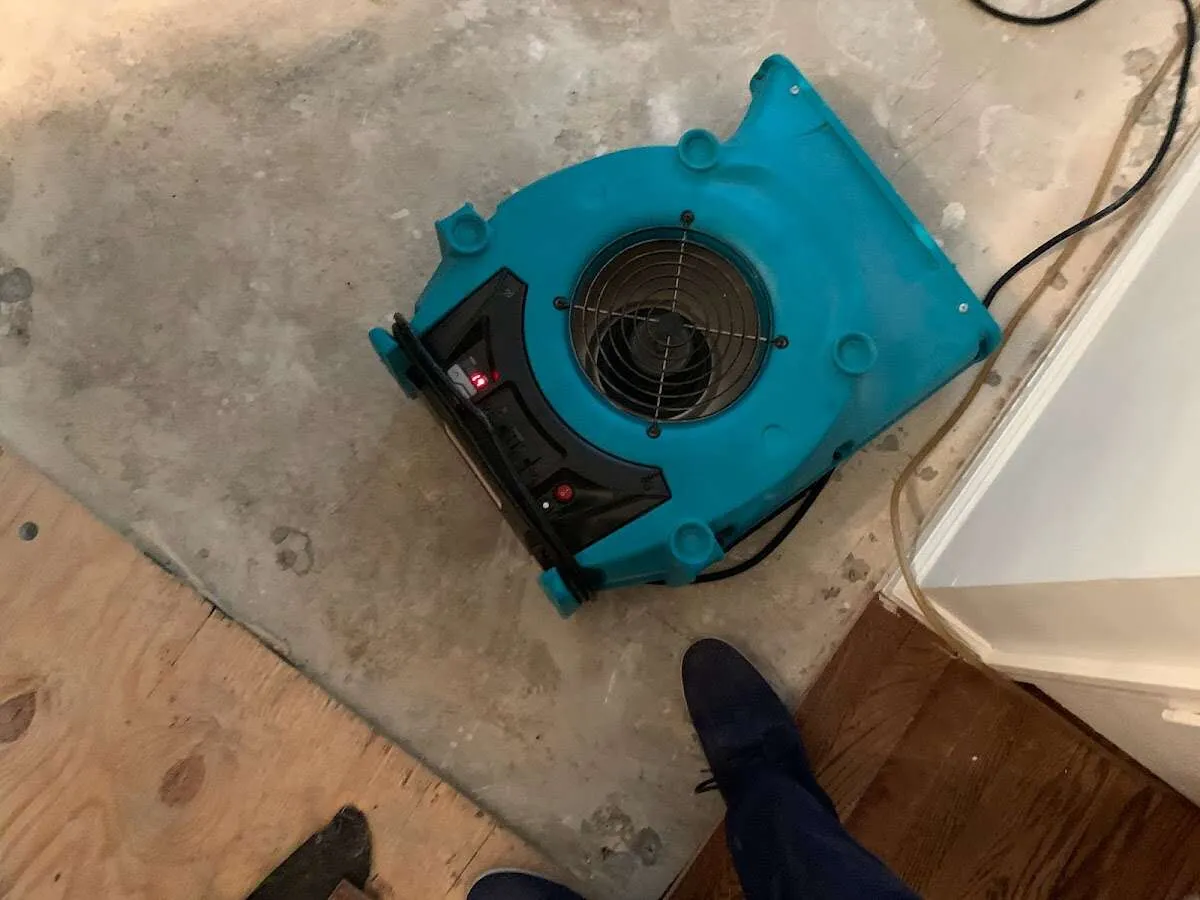 Air mover drying subfloor during Commercial Water Damage Restoration in Spokane